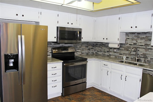 kitchen with white cabinetry, stainless steel appliances, and a sink