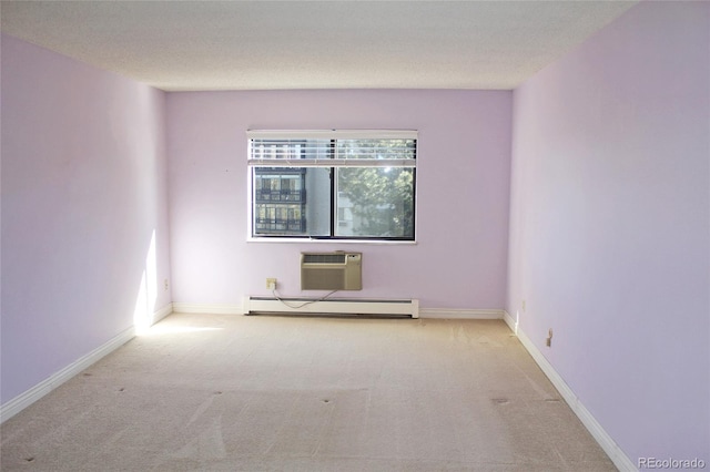 carpeted empty room featuring a baseboard heating unit, a wall mounted air conditioner, a textured ceiling, and baseboards