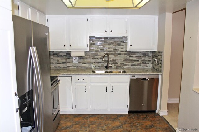 kitchen featuring appliances with stainless steel finishes, white cabinets, and a sink