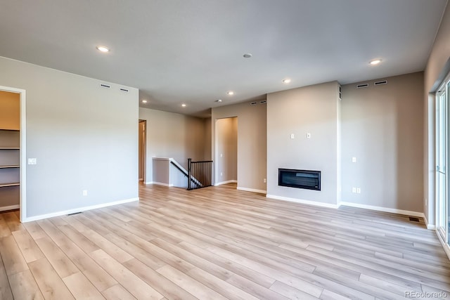 unfurnished living room featuring light hardwood / wood-style floors