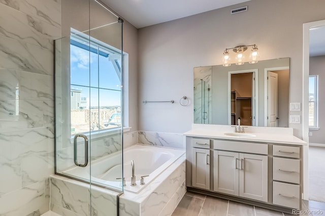 bathroom featuring vanity and separate shower and tub