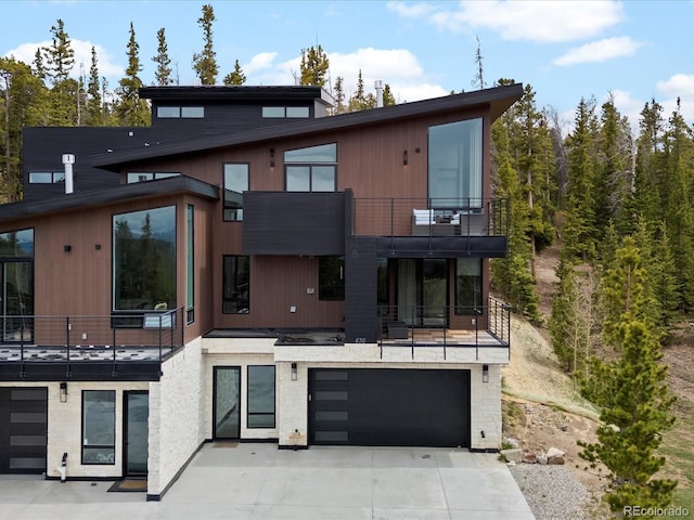 436 N Fuller Placer Rd, Breckenridge, CO 80424 - back of house with a balcony, a garage, and concrete driveway