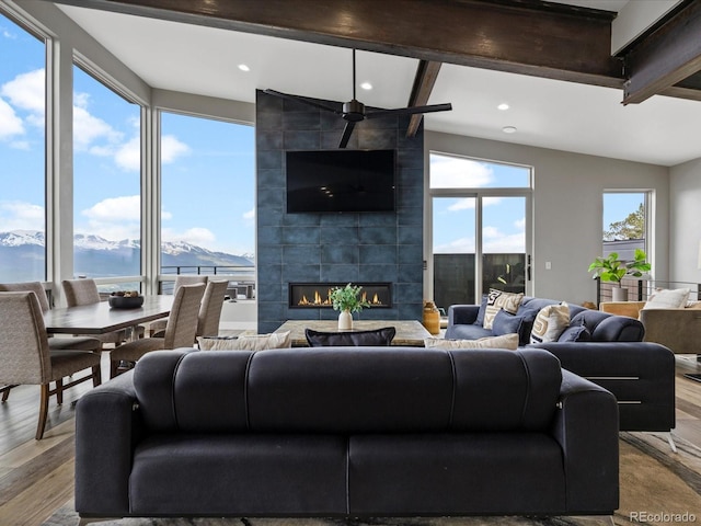 436 N Fuller Placer Rd, Breckenridge, CO 80424 - living room with beamed ceiling, wood finished floors, a tiled fireplace, and recessed lighting