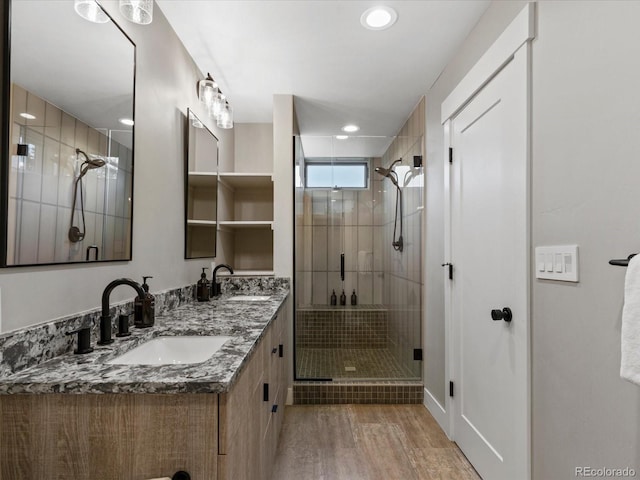 436 N Fuller Placer Rd, Breckenridge, CO 80424 - bathroom with a shower stall, double vanity, wood finished floors, and recessed lighting