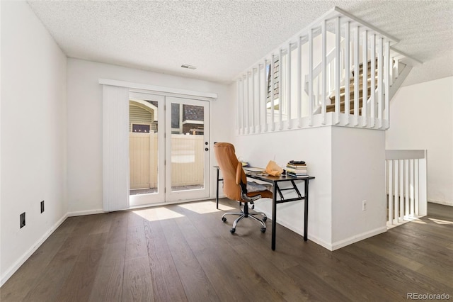 home office with a textured ceiling, french doors, wood finished floors, and baseboards