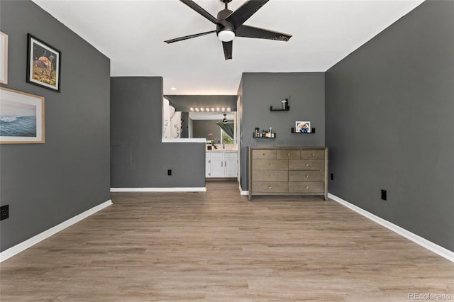 bedroom featuring light wood-type flooring, baseboards, ensuite bath, and ceiling fan