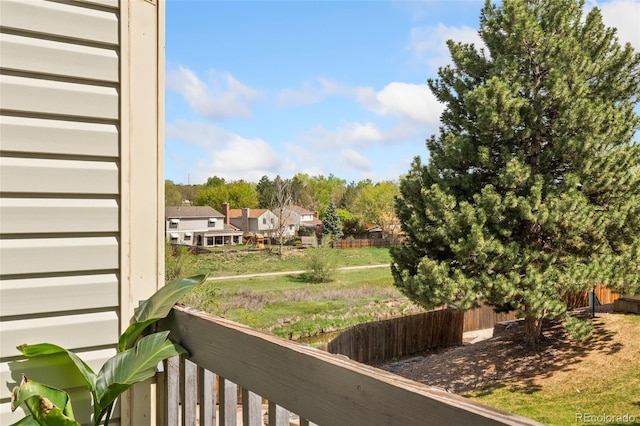 view of yard featuring fence and a residential view