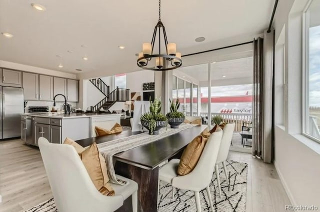 16488 W 92nd Pl, Arvada, CO 80007 - dining area with plenty of natural light, a chandelier, and light wood-style floors