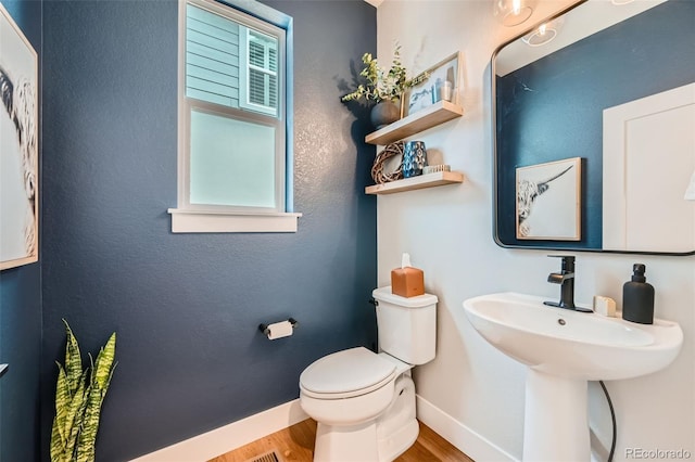 2840 E 102nd Pl, Thornton, CO 80229 - half bathroom with baseboards and wood finished floors