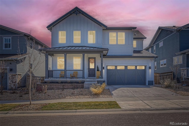 2840 E 102nd Pl, Thornton, CO 80229 - view of front facade featuring covered porch, board and batten siding, a garage, and concrete driveway