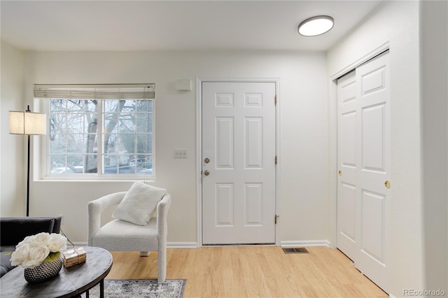 entrance foyer featuring visible vents, baseboards, and light wood finished floors