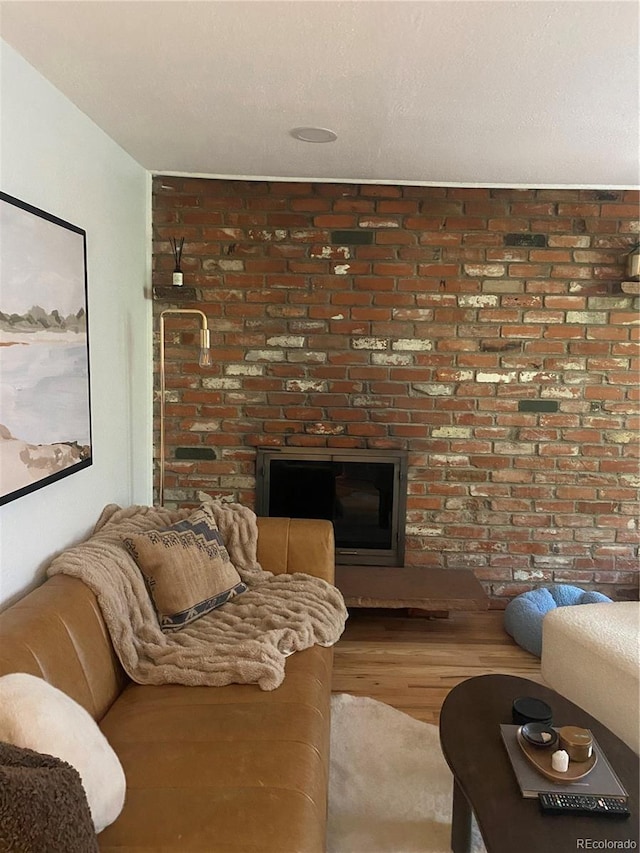 155 S Pennsylvania St Unit 209, Denver, CO 80209 - living area featuring a brick fireplace and wood finished floors
