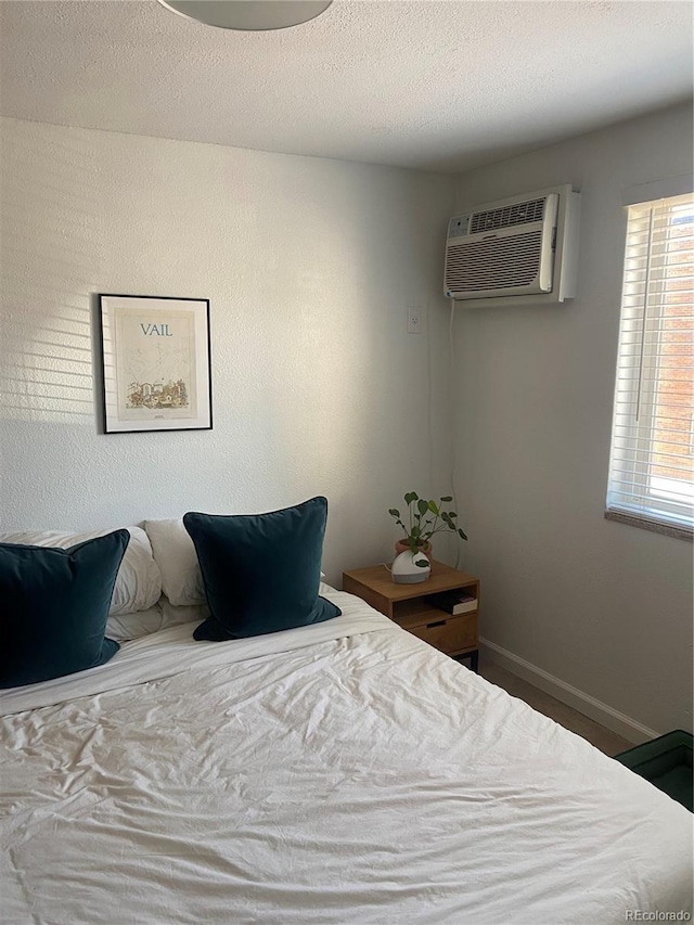 155 S Pennsylvania St Unit 209, Denver, CO 80209 - bedroom featuring baseboards and a wall unit AC