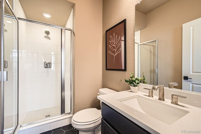 bathroom with a shower with door, toilet, tile patterned flooring, and vanity