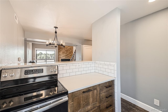 303 W Lehow Ave Unit 22, Englewood, CO 80110 - kitchen featuring stainless steel electric range, a chandelier, dark wood-style floors, light countertops, and decorative light fixtures