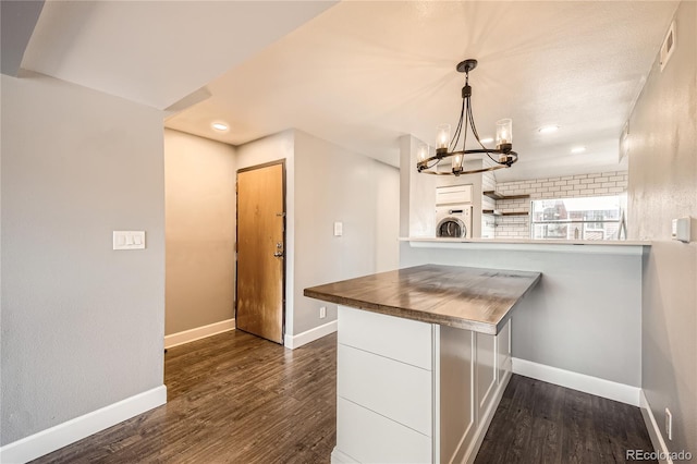 303 W Lehow Ave Unit 22, Englewood, CO 80110 - kitchen with washer / dryer, white cabinets, a chandelier, dark wood-type flooring, and recessed lighting