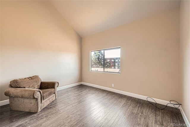 303 W Lehow Ave Unit 22, Englewood, CO 80110 - living area with dark wood-style flooring and vaulted ceiling