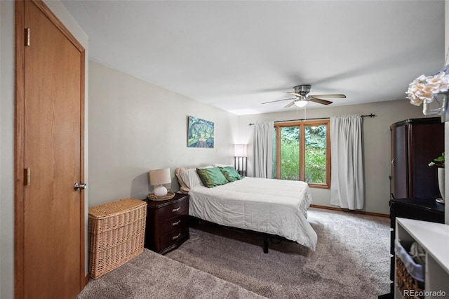 carpeted bedroom featuring ceiling fan and baseboards