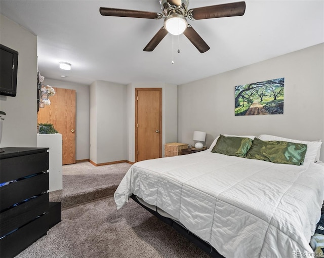 carpeted bedroom featuring ceiling fan and baseboards