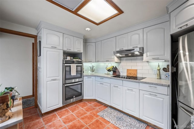 kitchen featuring under cabinet range hood, tasteful backsplash, light tile patterned floors, and appliances with stainless steel finishes