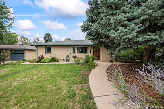 single story home with an attached garage, brick siding, and a front yard