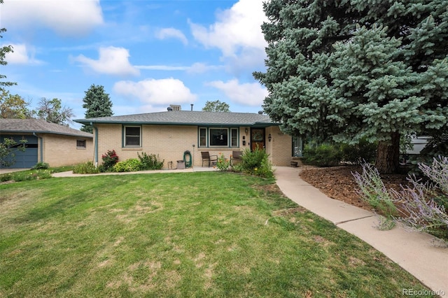 ranch-style house featuring brick siding and a front yard