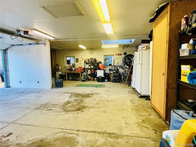 garage featuring freestanding refrigerator and a garage door opener