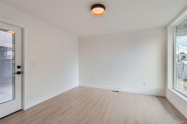 spare room with light hardwood / wood-style floors