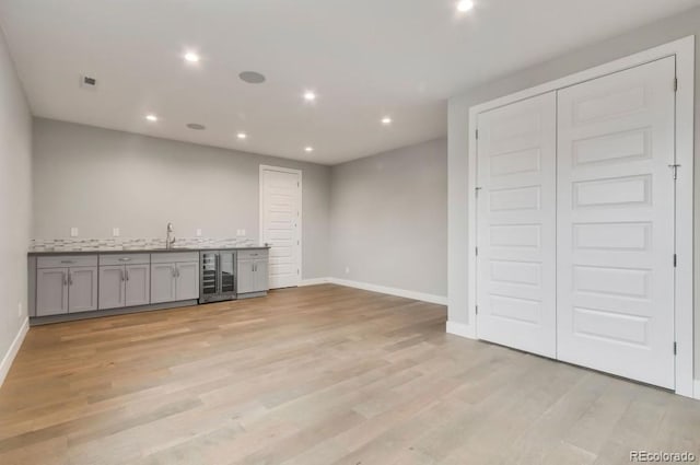 1744 Barefoot Dr, Windsor, CO 80550 - indoor wet bar featuring light wood-style floors, recessed lighting, and wine cooler