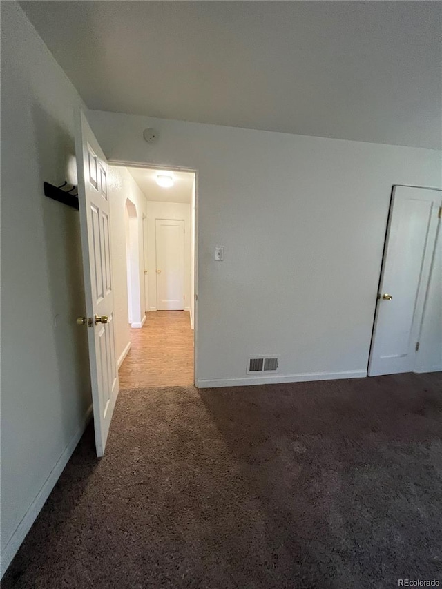 unfurnished room featuring light carpet