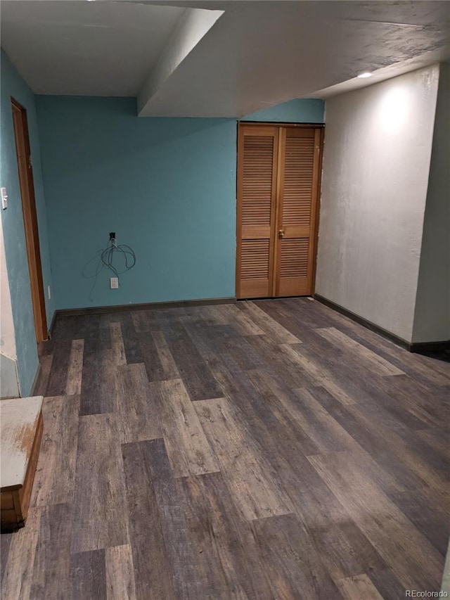 unfurnished room with dark hardwood / wood-style flooring