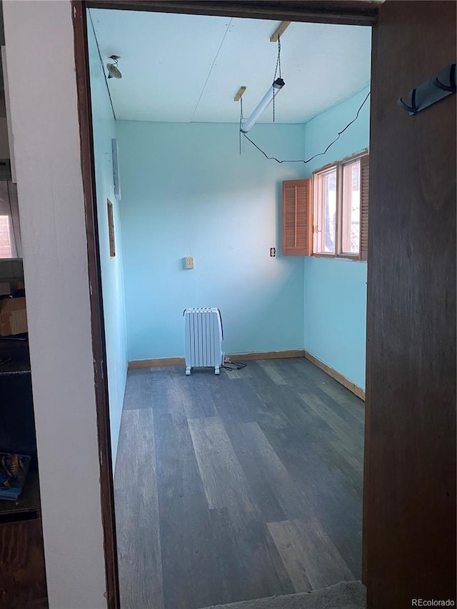 unfurnished room with wood finished floors and baseboards