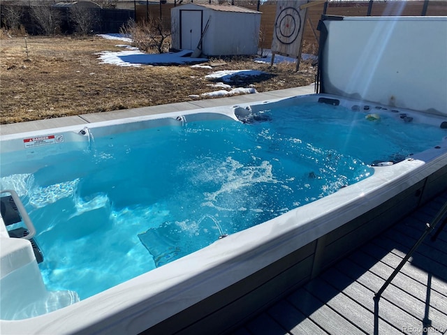 exterior space featuring fence and a hot tub