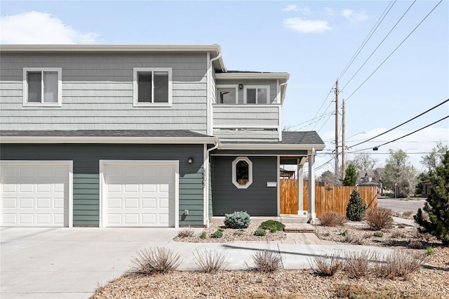 3402 N Clayton St, Denver, CO 80205 - view of front facade featuring a balcony, an attached garage, and driveway