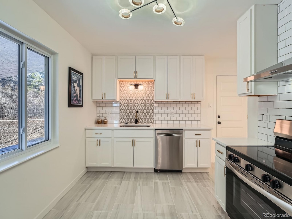 kitchen featuring a healthy amount of sunlight, white cabinetry, sink, and appliances with stainless steel finishes