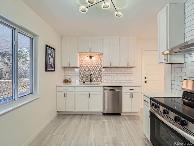 kitchen featuring a healthy amount of sunlight, white cabinetry, sink, and appliances with stainless steel finishes