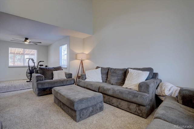 carpeted living room with ceiling fan