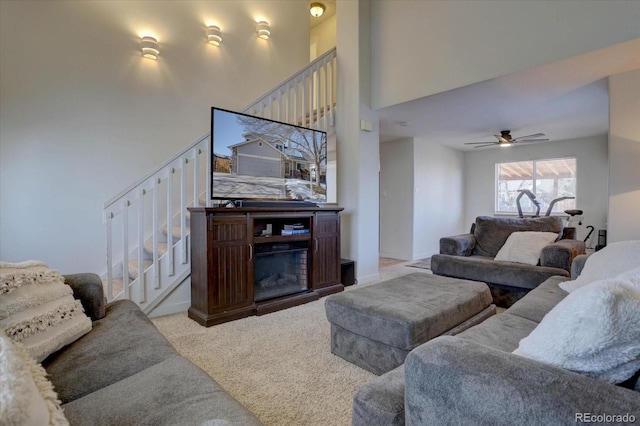 living room with light carpet and a high ceiling