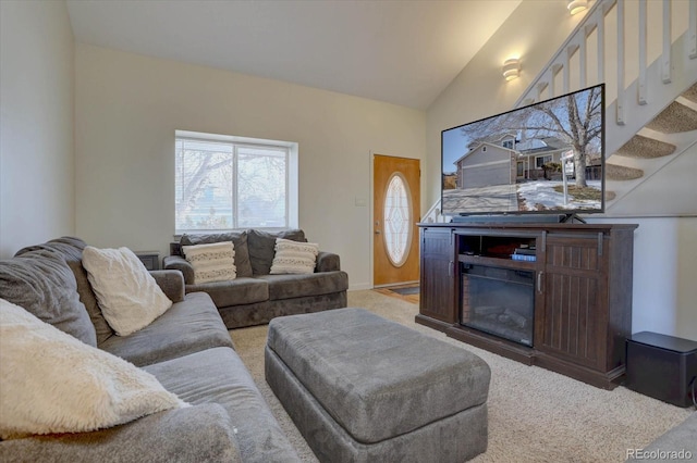 living room with lofted ceiling and carpet flooring