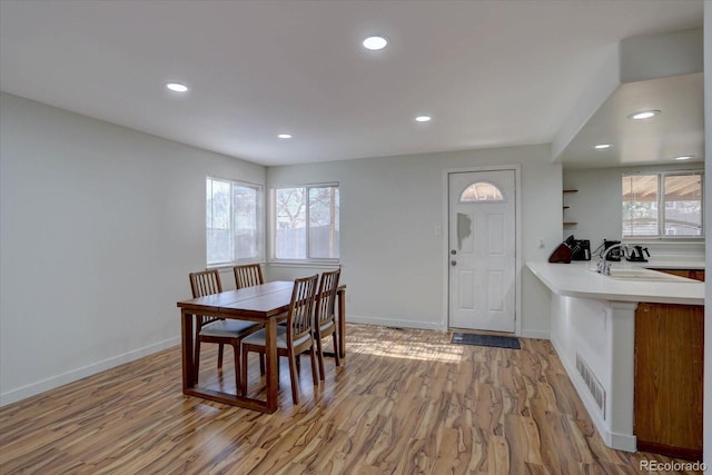 dining room with sink and light hardwood / wood-style floors