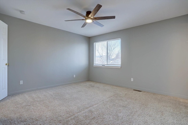 spare room with light carpet and ceiling fan