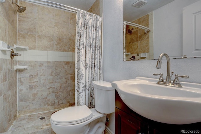 bathroom featuring vanity, toilet, and curtained shower