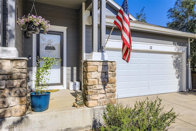 12 Apache Plume St, Brighton, CO 80601 - entrance to property with stone siding, a garage, and driveway