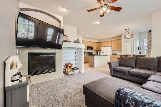 12 Apache Plume St, Brighton, CO 80601 - living area featuring ceiling fan, light colored carpet, a fireplace, and recessed lighting