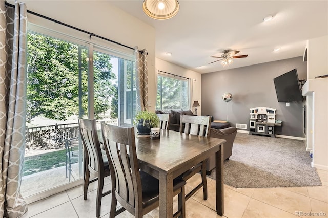 12 Apache Plume St, Brighton, CO 80601 - dining room featuring light tile patterned floors, a ceiling fan, and light colored carpet