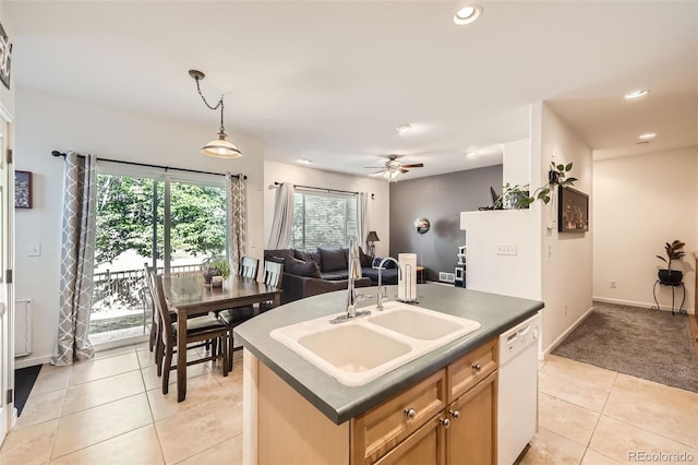 12 Apache Plume St, Brighton, CO 80601 - kitchen featuring white dishwasher, dark countertops, light tile patterned flooring, healthy amount of natural light, and recessed lighting