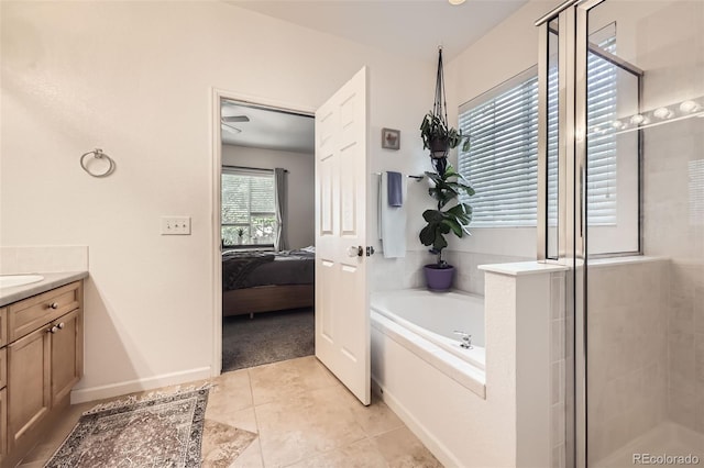 12 Apache Plume St, Brighton, CO 80601 - bathroom with a bath, ensuite bath, a shower stall, vanity, and tile patterned floors