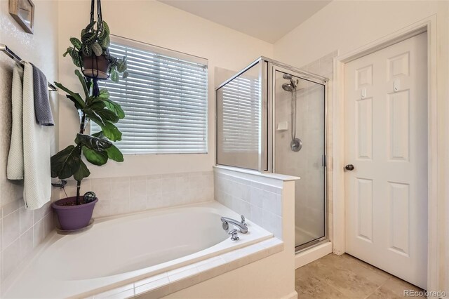 12 Apache Plume St, Brighton, CO 80601 - bathroom featuring a shower stall, a garden tub, and tile patterned floors