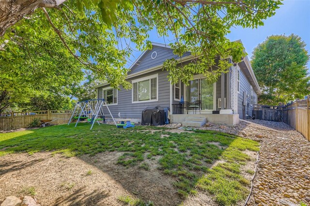 12 Apache Plume St, Brighton, CO 80601 - back of house featuring a fenced backyard and entry steps