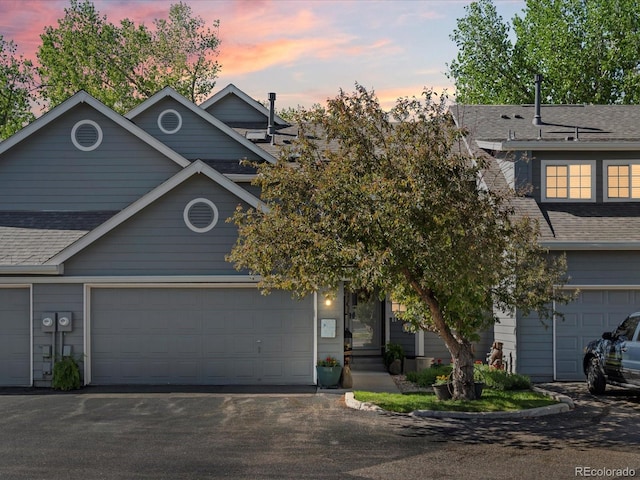 5006 S Nelson St Unit B, Littleton, CO 80127 - view of front of property featuring roof with shingles, asphalt driveway, and a garage